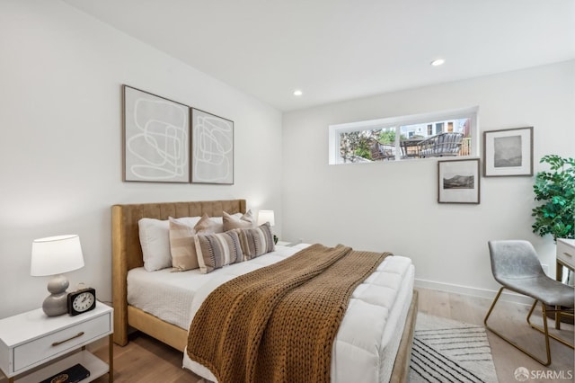 bedroom with wood finished floors and recessed lighting