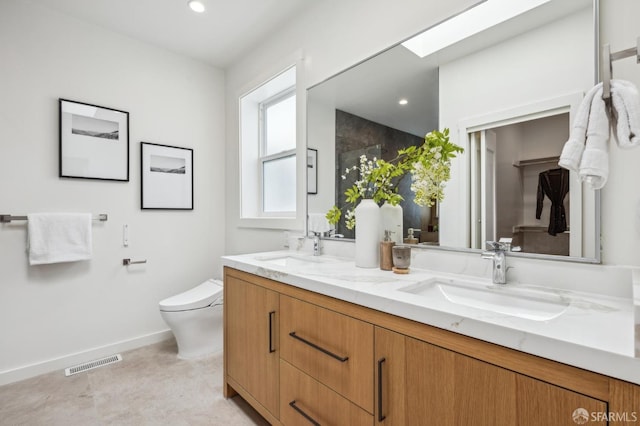 bathroom with toilet, a shower with shower door, baseboards, double vanity, and recessed lighting