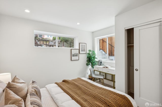 bedroom with recessed lighting and a closet