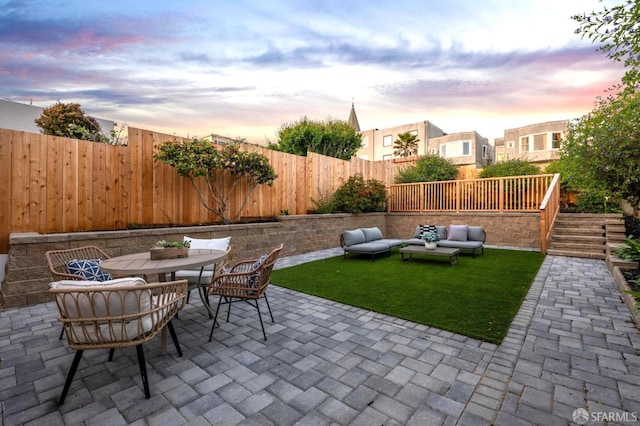 view of patio / terrace with a fenced backyard, outdoor dining area, and an outdoor hangout area