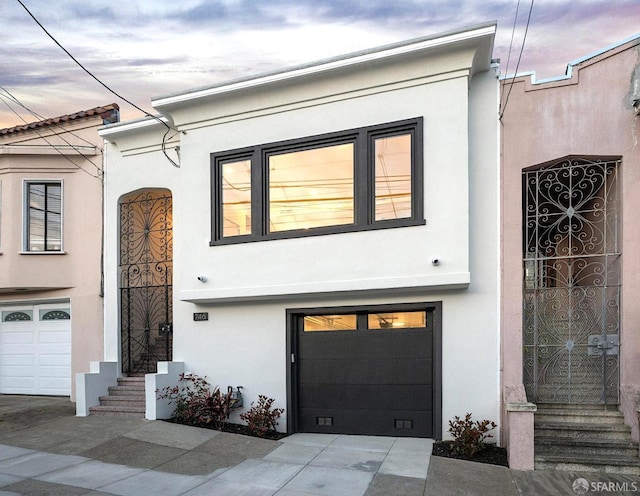 view of front of home with stucco siding and an attached garage
