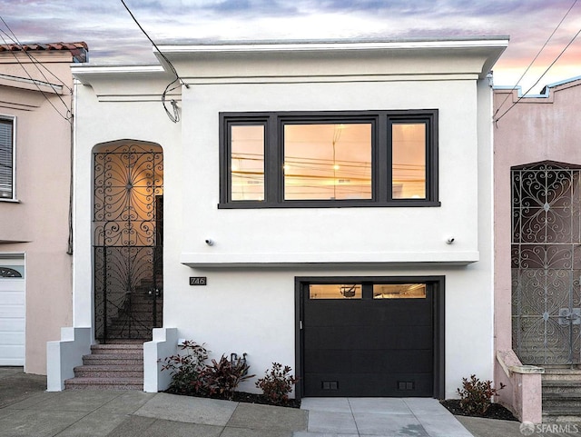 view of front of property with stucco siding and a garage
