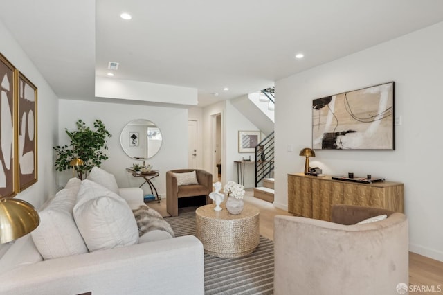 living area with stairway, recessed lighting, and baseboards