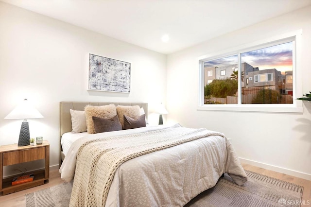 bedroom featuring wood finished floors and baseboards