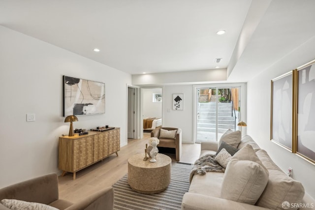 living area featuring light wood-style flooring and recessed lighting