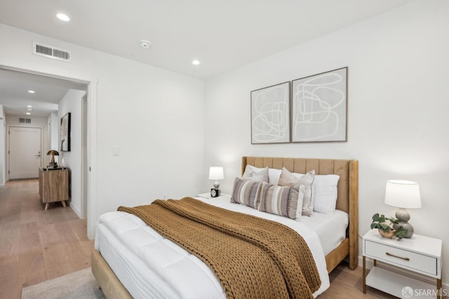 bedroom with light wood-type flooring and recessed lighting