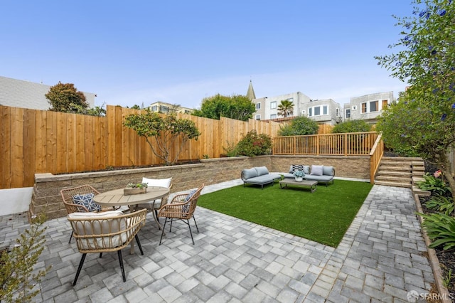 view of patio / terrace featuring a fenced backyard, outdoor dining space, and outdoor lounge area