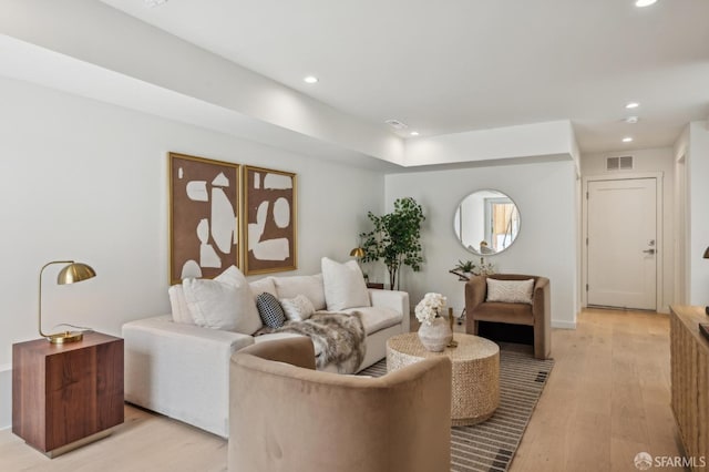 living room with light wood-style floors and recessed lighting