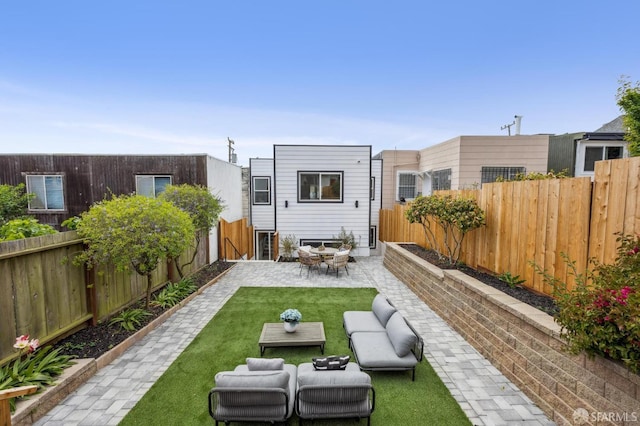 back of house featuring a patio area and an outdoor hangout area