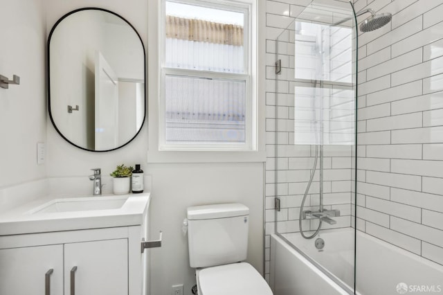 bathroom featuring toilet, vanity, and bathtub / shower combination