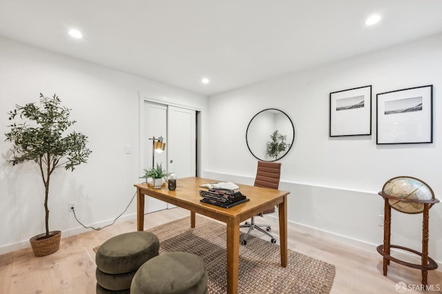 office space featuring light wood finished floors, recessed lighting, and baseboards
