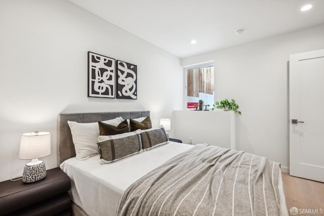 bedroom featuring light wood-style flooring and recessed lighting