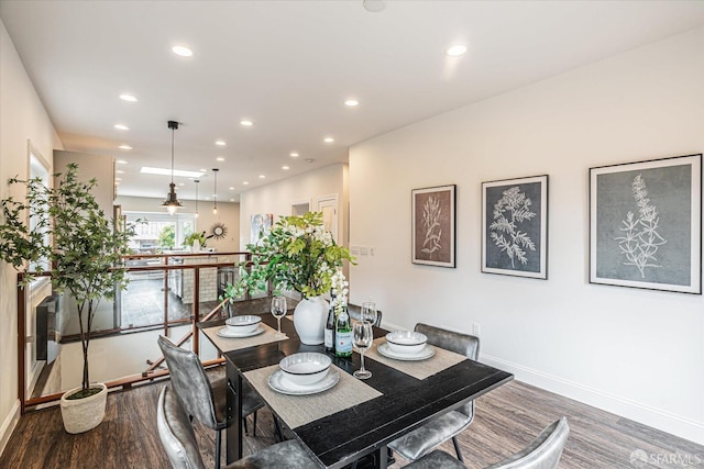 dining space with dark hardwood / wood-style floors