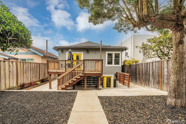 back of house featuring a patio area and a deck