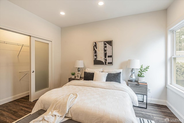 bedroom featuring dark hardwood / wood-style floors and a closet