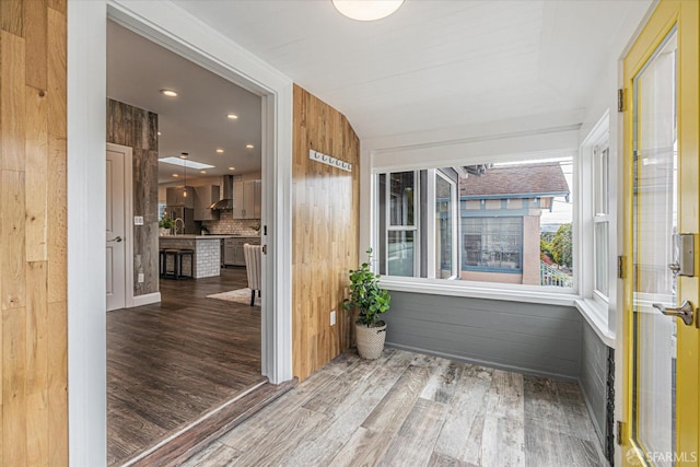 sunroom / solarium featuring sink and vaulted ceiling