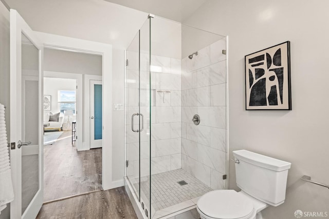 bathroom with hardwood / wood-style floors, toilet, and walk in shower