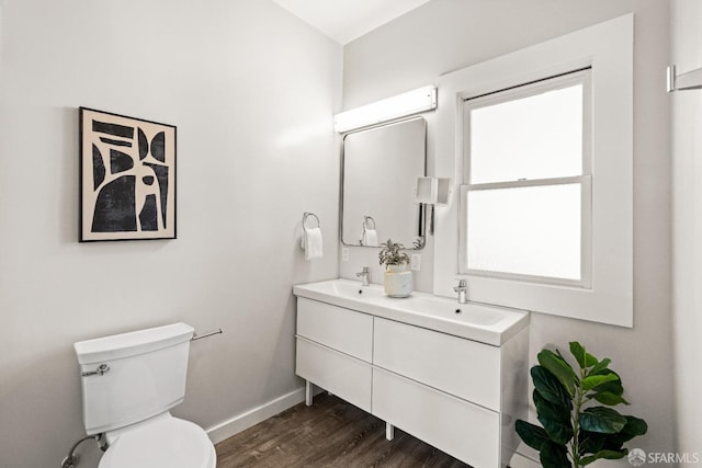 bathroom featuring wood-type flooring, vanity, and toilet