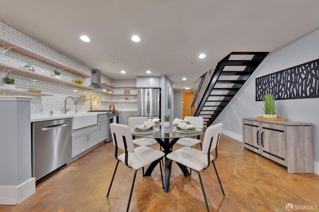 dining area featuring concrete floors, stairs, baseboards, and recessed lighting
