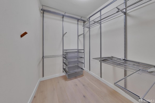 spacious closet with wood finished floors