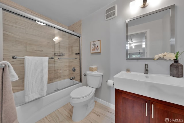 full bathroom with baseboards, toilet, combined bath / shower with glass door, and vanity