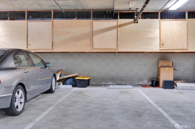 parking garage featuring concrete block wall