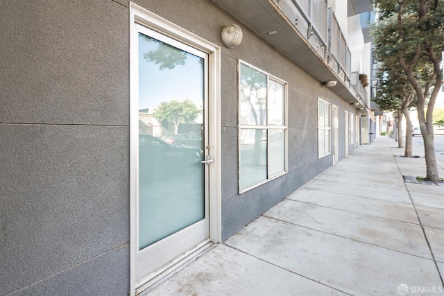 entrance to property with stucco siding