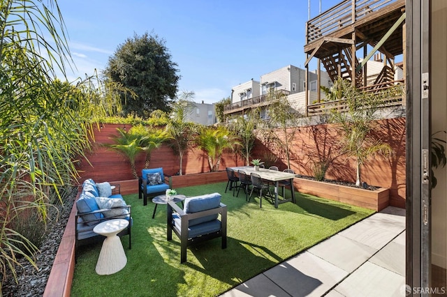 view of yard featuring a patio area, outdoor lounge area, and a fenced backyard