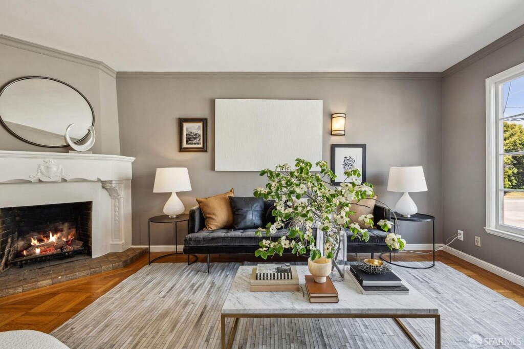 5039 California St, San Francisco, CA 94118 - living area with baseboards, ornamental molding, a lit fireplace, and plenty of natural light