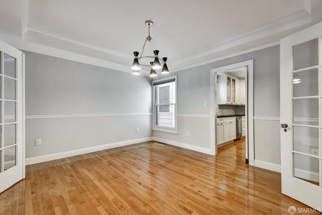 1258 York St, San Francisco, CA 94110 - empty room featuring ornamental molding, a chandelier, light wood-type flooring, and a tray ceiling