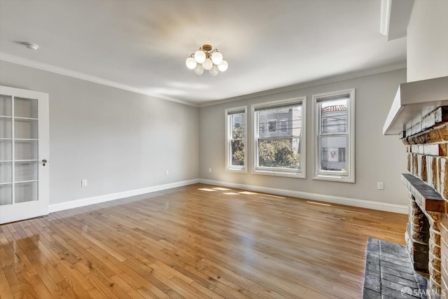 1258 York St, San Francisco, CA 94110 - unfurnished living room with light wood-type flooring, crown molding, a fireplace, and a chandelier