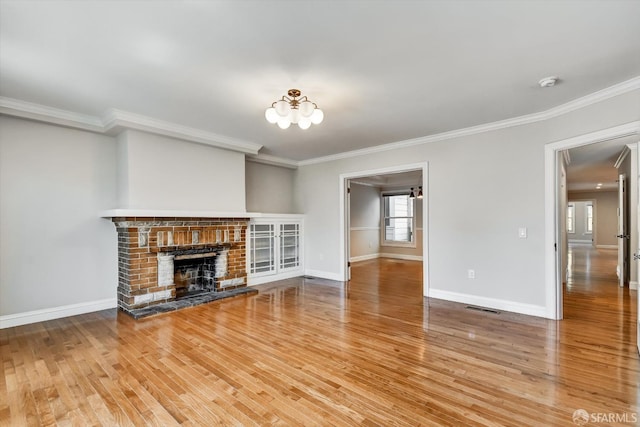 1258 York St, San Francisco, CA 94110 - unfurnished living room with wood finished floors, ornamental molding, a chandelier, and a brick fireplace