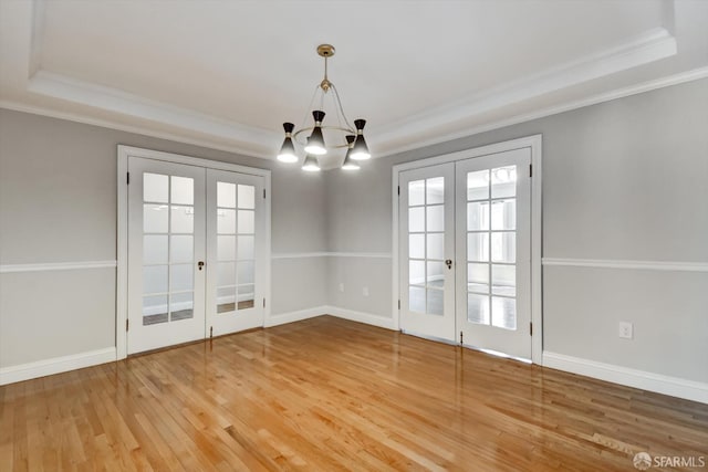 1258 York St, San Francisco, CA 94110 - unfurnished dining area featuring french doors, a raised ceiling, ornamental molding, and wood finished floors