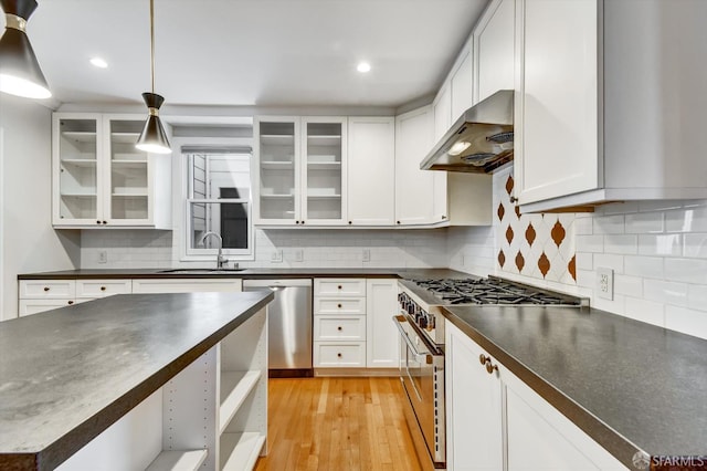 1258 York St, San Francisco, CA 94110 - kitchen with stainless steel appliances, ventilation hood, dark countertops, white cabinets, and recessed lighting