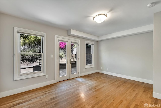 1258 York St, San Francisco, CA 94110 - empty room with french doors, a smoke detector, and light wood finished floors