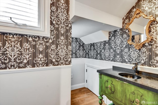 1258 York St, San Francisco, CA 94110 - bathroom with wallpapered walls, a wainscoted wall, wood finished floors, and vanity