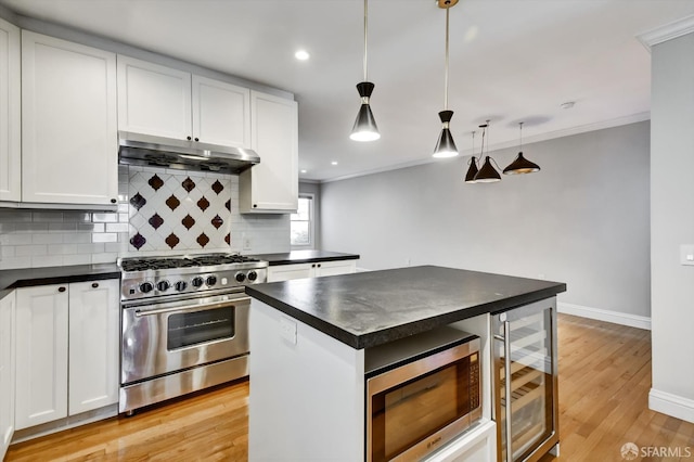 1258 York St, San Francisco, CA 94110 - kitchen with stainless steel appliances, beverage cooler, under cabinet range hood, dark countertops, and decorative backsplash