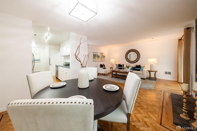 dining room featuring baseboards and visible vents
