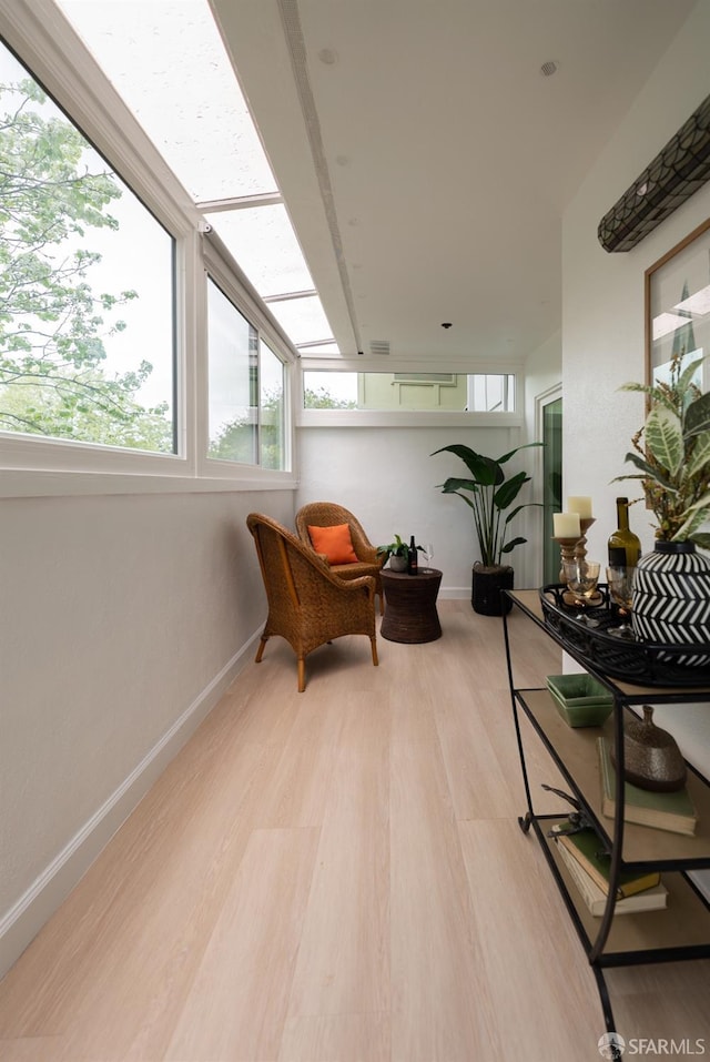 interior space featuring light wood finished floors and baseboards