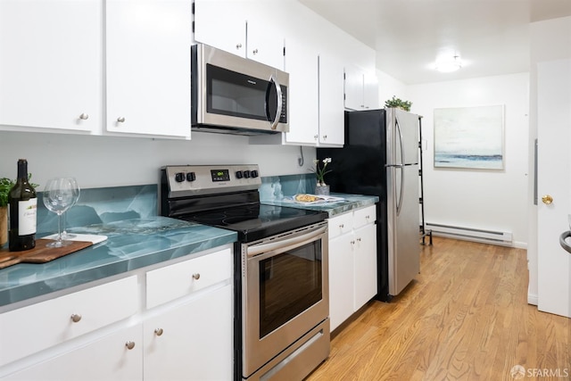 kitchen featuring light wood-style flooring, a baseboard radiator, white cabinetry, and stainless steel appliances