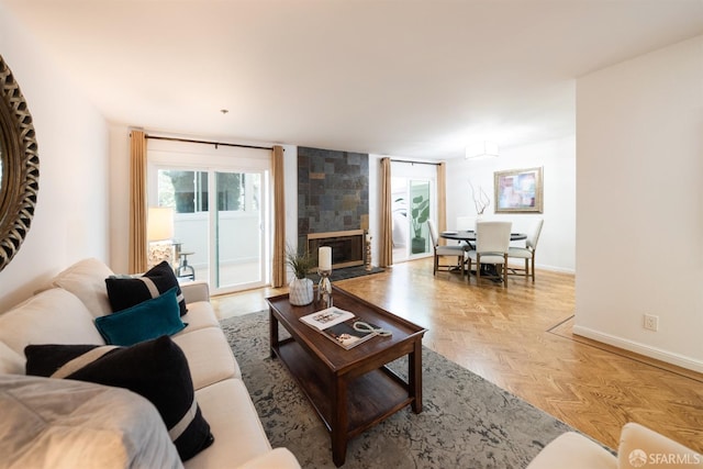 living area with a fireplace and baseboards