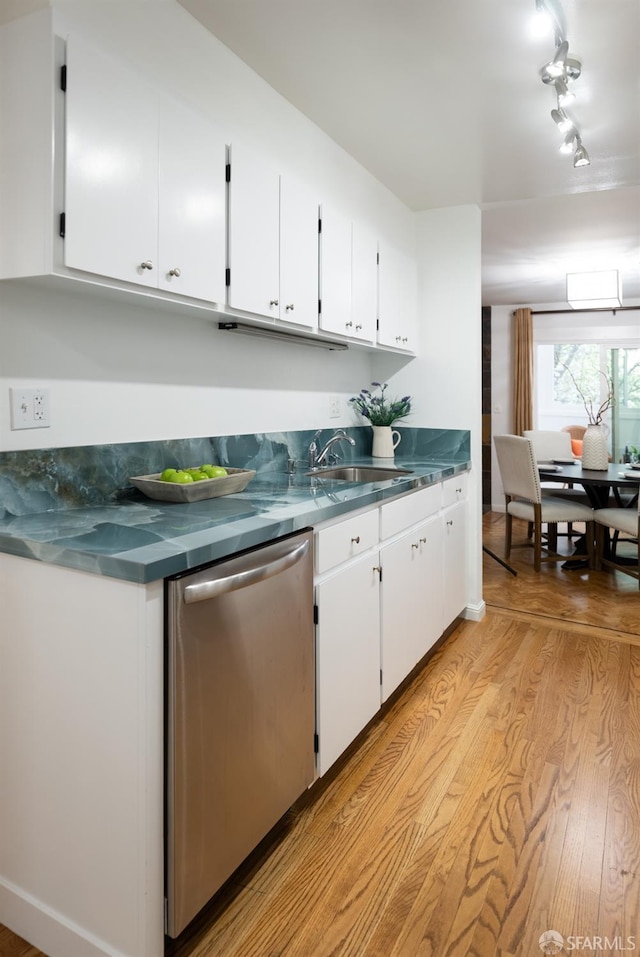 kitchen featuring a sink, light wood-style flooring, white cabinetry, and dishwasher