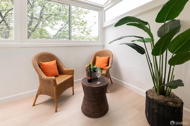 living area with wood finished floors and baseboards