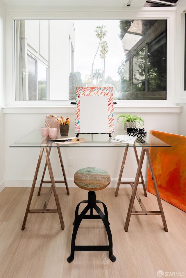 interior space featuring baseboards and light wood finished floors