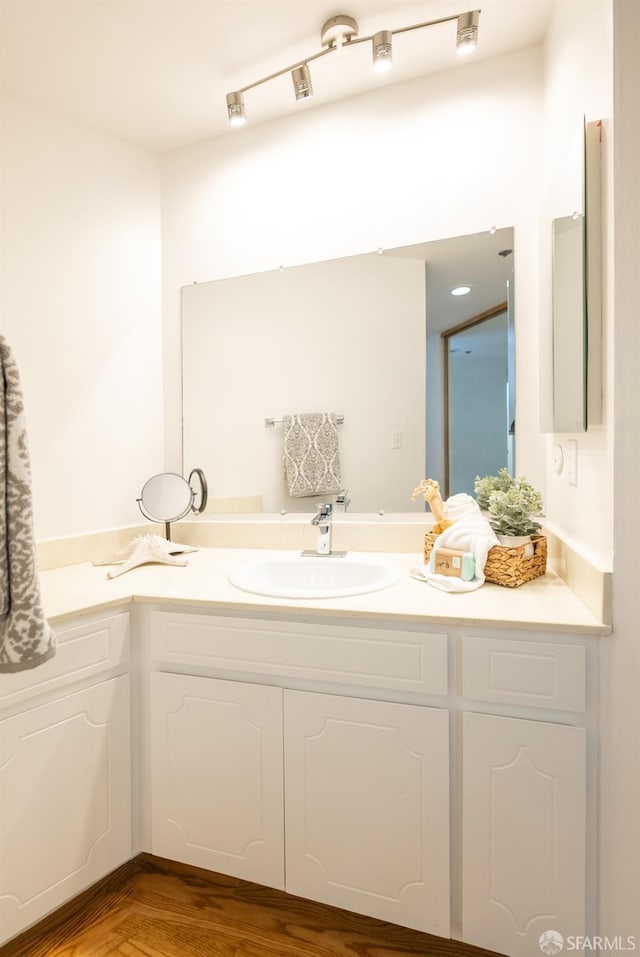 bathroom featuring vanity and wood finished floors