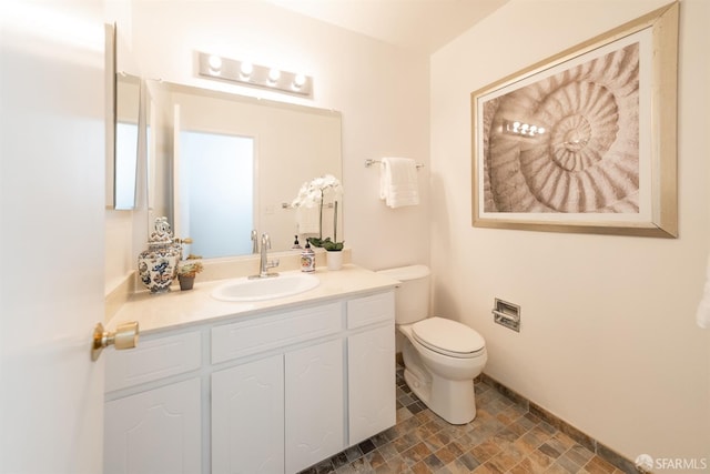 bathroom featuring toilet and vanity