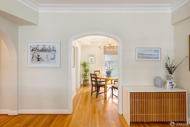 2201 Sacramento St Unit 404, San Francisco, CA 94115 - corridor featuring ornamental molding, radiator, arched walkways, light wood-style flooring, and a notable chandelier