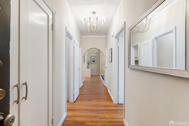 2201 Sacramento St Unit 404, San Francisco, CA 94115 - corridor with ornamental molding, baseboards, light wood-type flooring, arched walkways, and a notable chandelier
