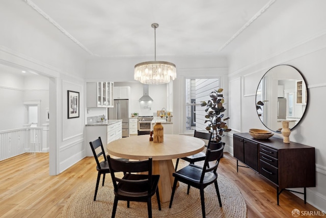 1980-1982 Fell St, San Francisco, CA 94117 - dining area featuring light wood-style flooring, a chandelier, and a decorative wall