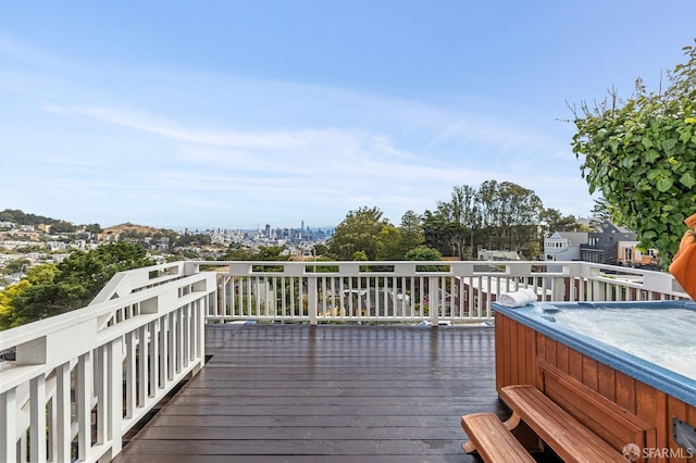 wooden deck with a hot tub